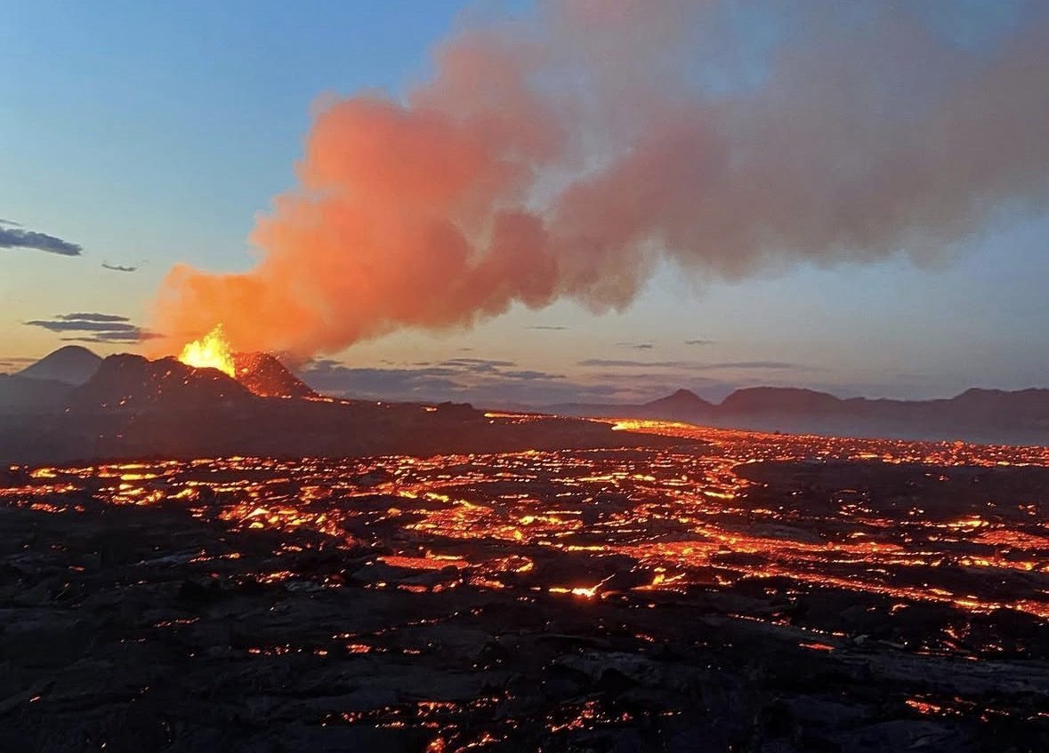 Hikers on a Fagradalsfjall Volcano Tour walking across black lava fields in Iceland